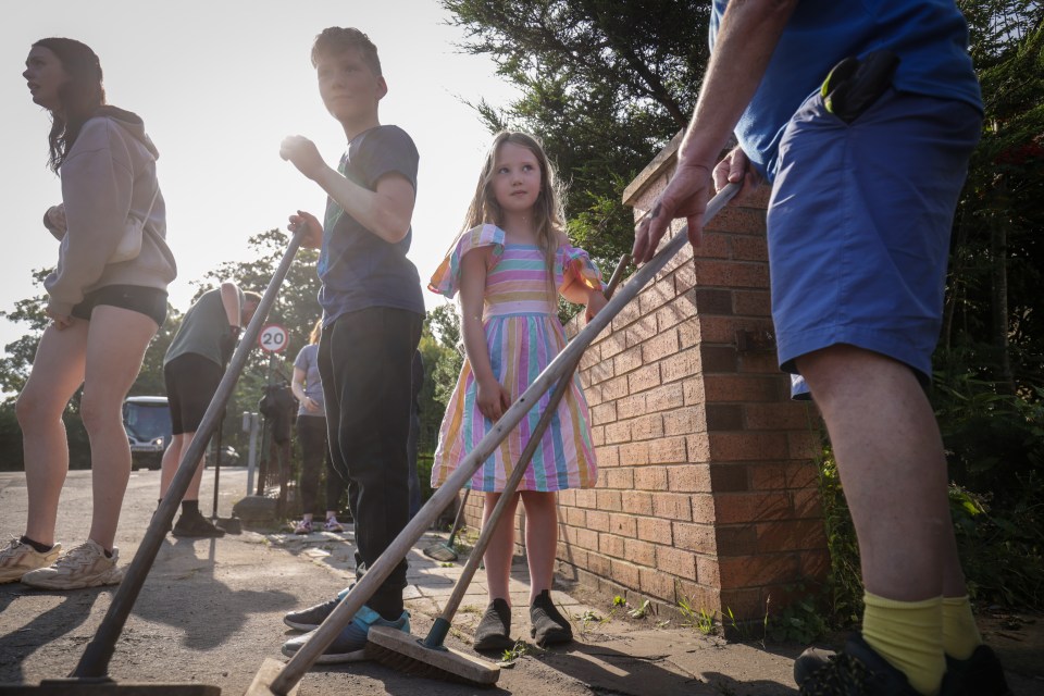 Sebastian Taylor, 10, and his sister Evelyn, aged seven, help to sweep Sussex Road