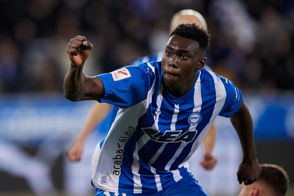 a soccer player wearing a blue and white striped shirt that says ea