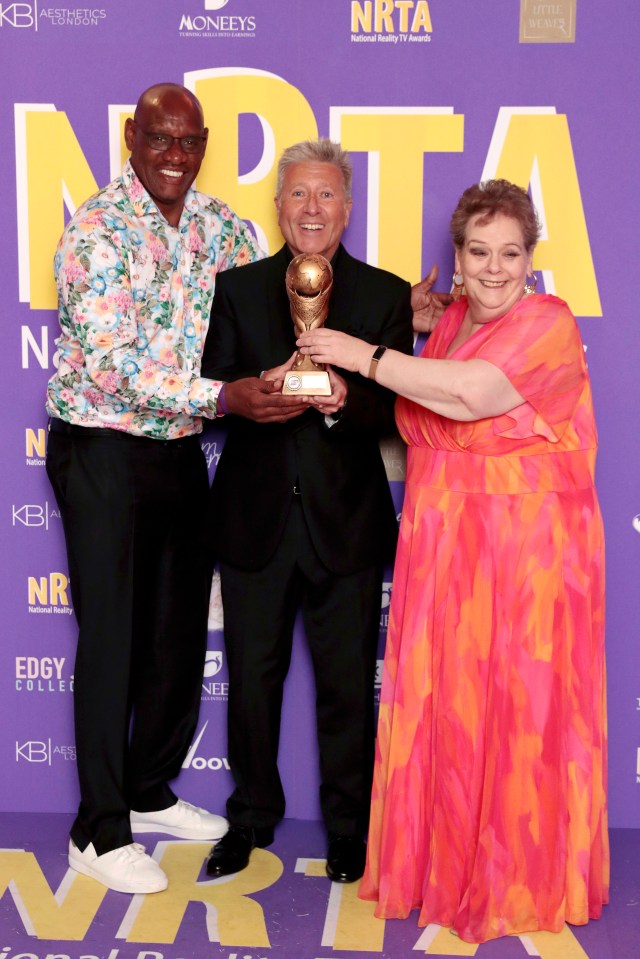 Shaun Wallace, Neil Fox and Anne Hegerty pose in the winners room with the Best Game Show Award at the National Reality TV Awards