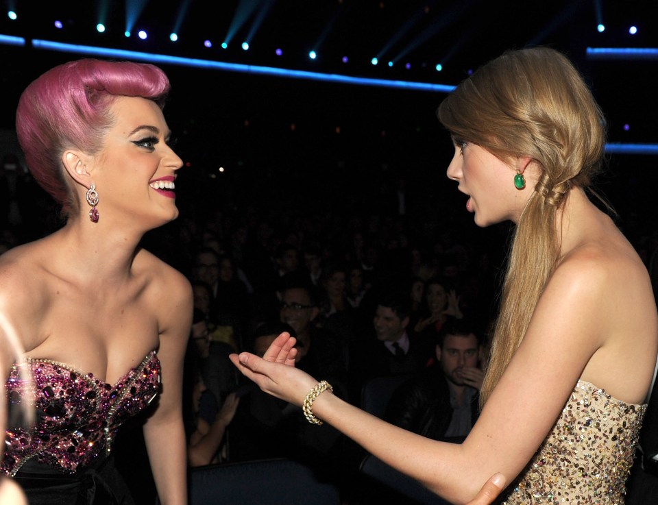 Taylor pictured in 2011 with Katy Perry, with a noticeably rounder back and shoulders