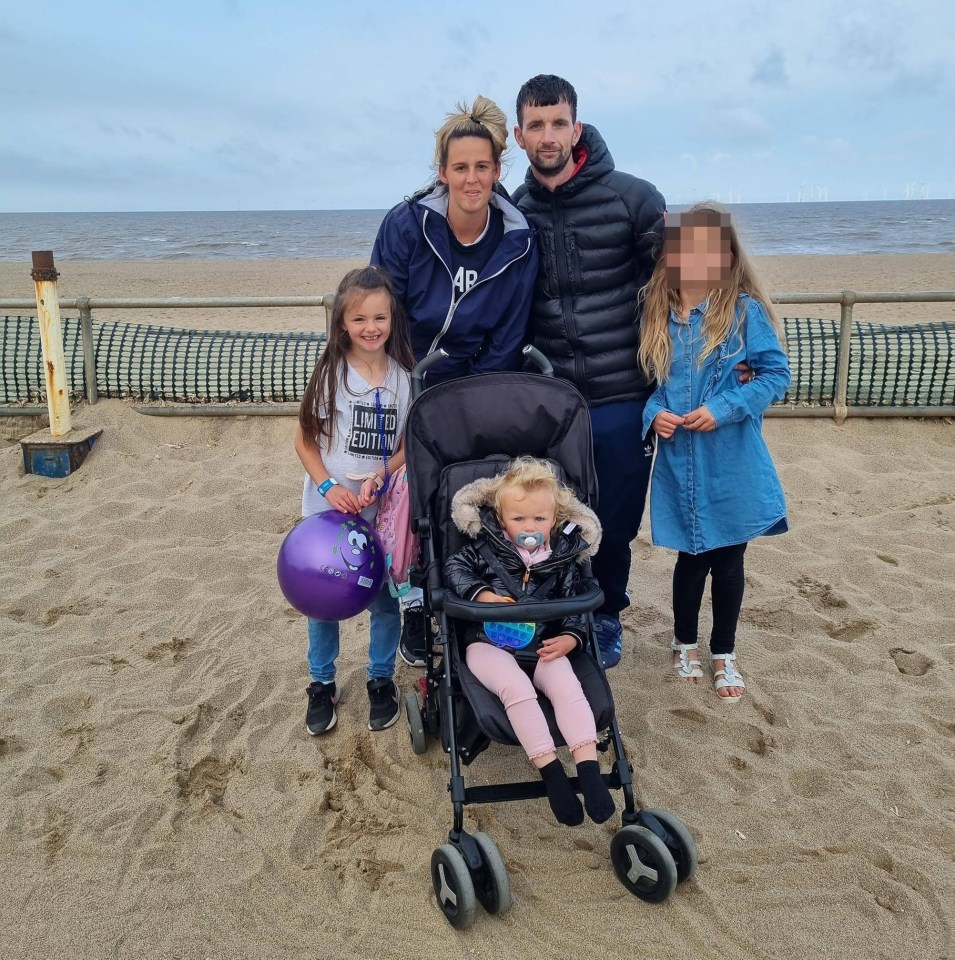 a family posing for a picture on the beach with one girl wearing a shirt that says gap