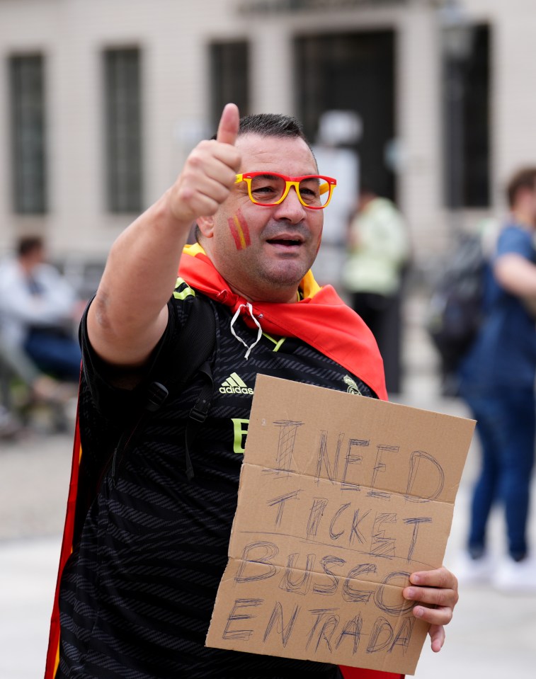 Hopeful! A Spain fan holds a sign requesting a ticket next to the Brandenburg Gate