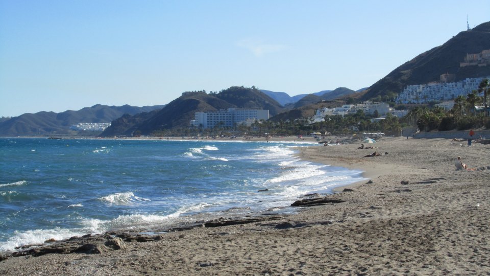 a beach with a white building in the background