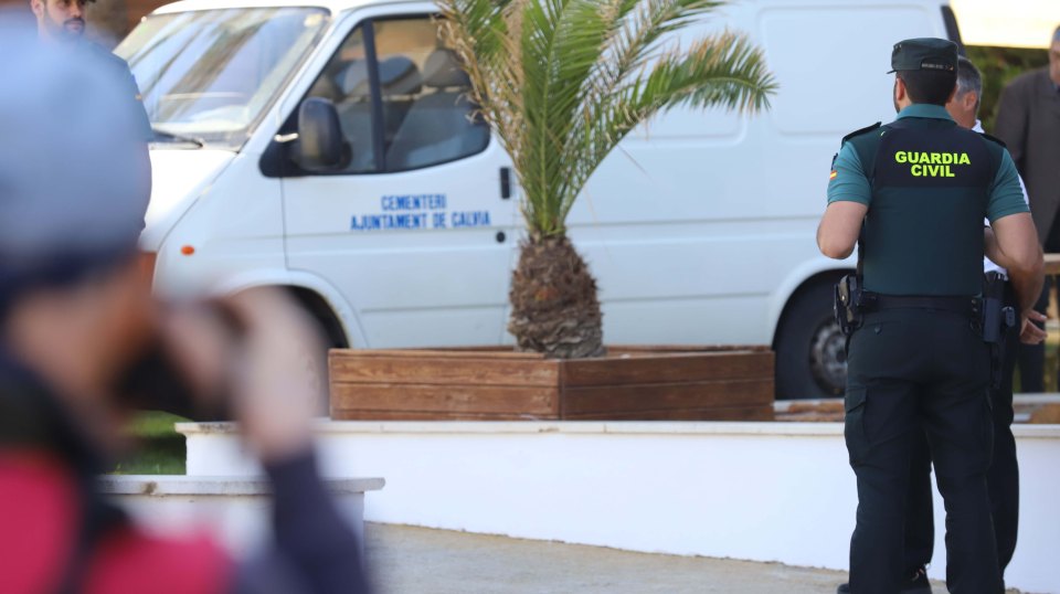 a man wearing a guardia civil uniform stands in front of a white van