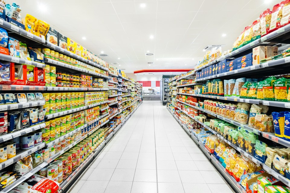 a grocery store aisle filled with pasta and other items