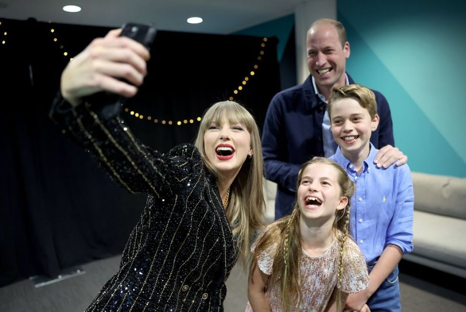 A delighted Princess Charlotte gets a selfie with Taylor Swift at Wembley with her brother George and dad