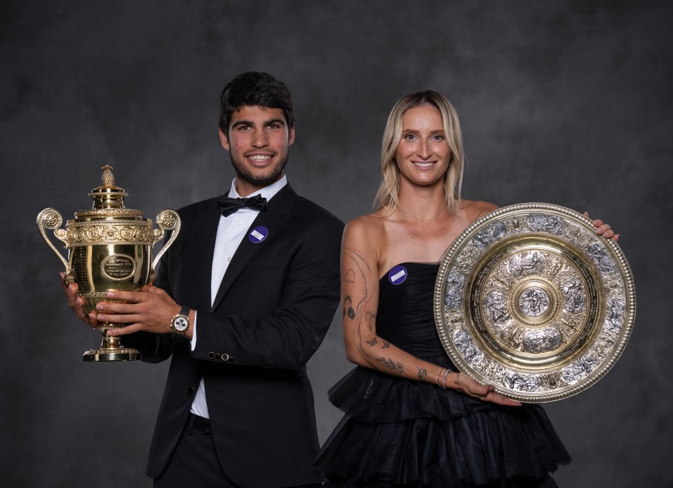 a man in a tuxedo and a woman in a black dress hold trophies