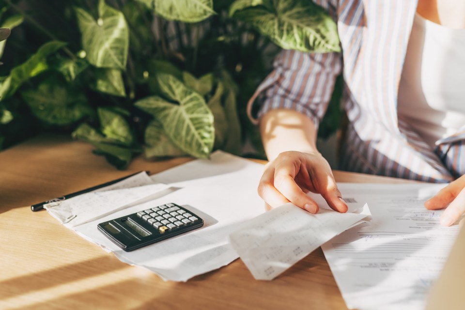 a calculator sits on a table next to a receipt