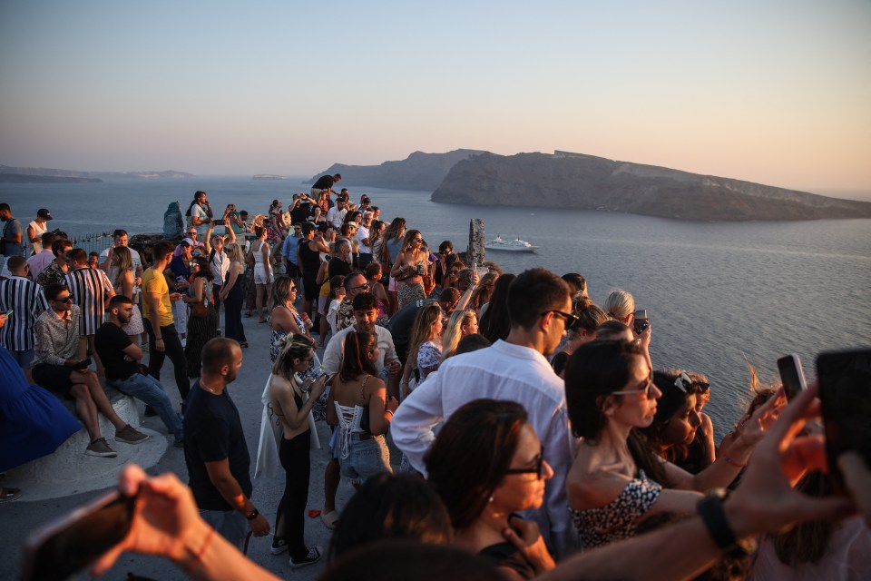 Tourists waiting for the sunset in the village of Oia on the Greek island of Santorini