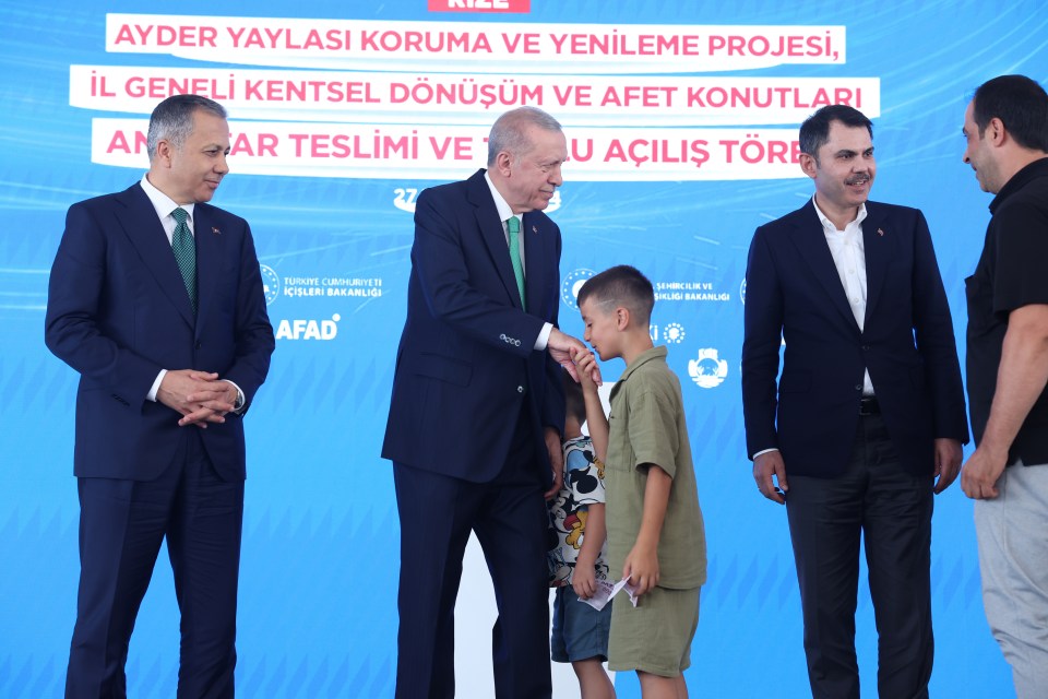 A second boy also joined Erdogan on stage and kissed the leader's hand