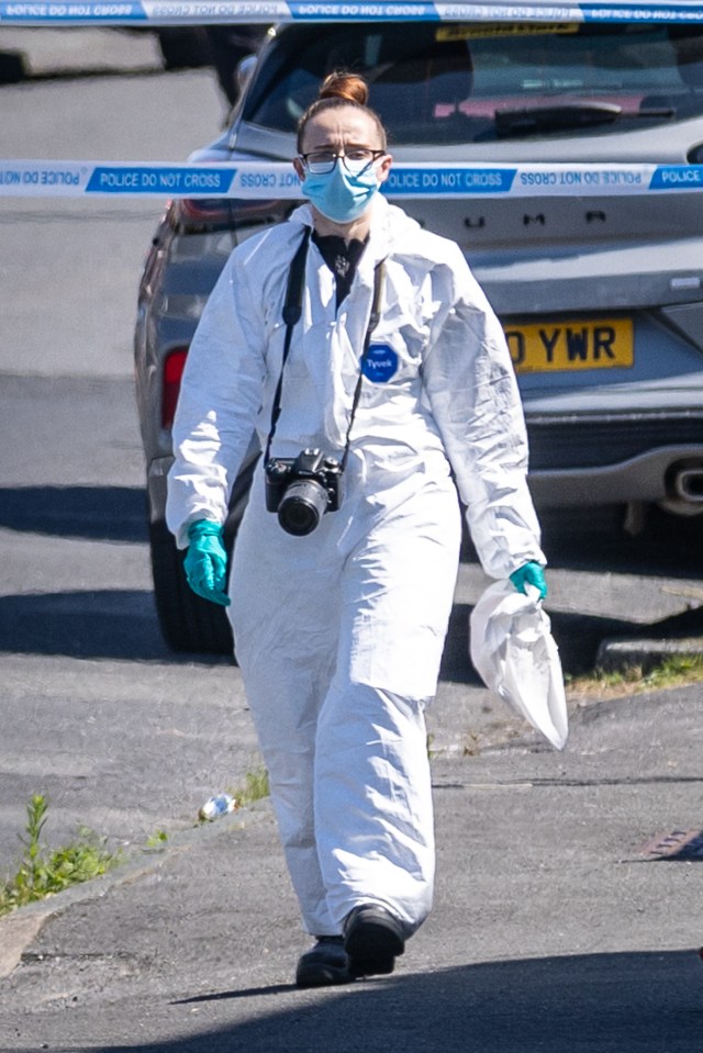 a woman in a protective suit with a camera and a license plate that says ynr