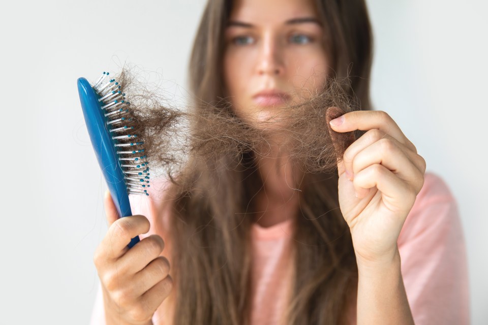 Young woman is very upset because of hair loss