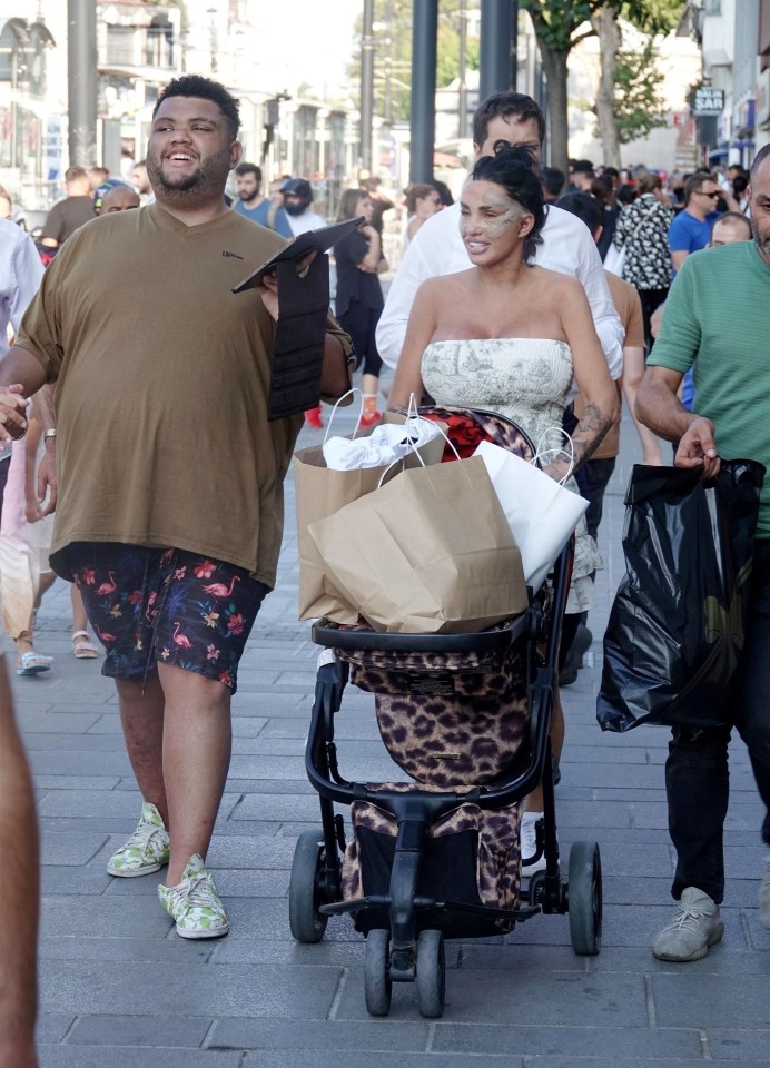 a woman pushing a stroller with a leopard print on it