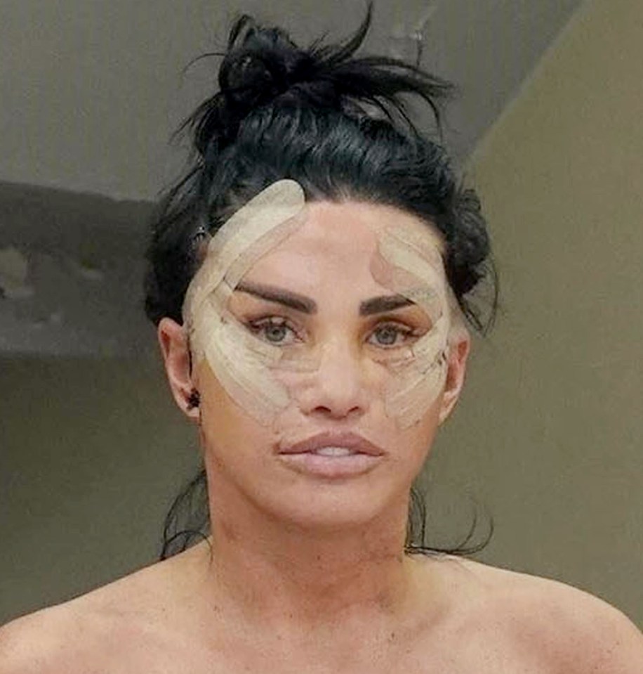 a woman with a bandage on her face is standing in front of a mirror .