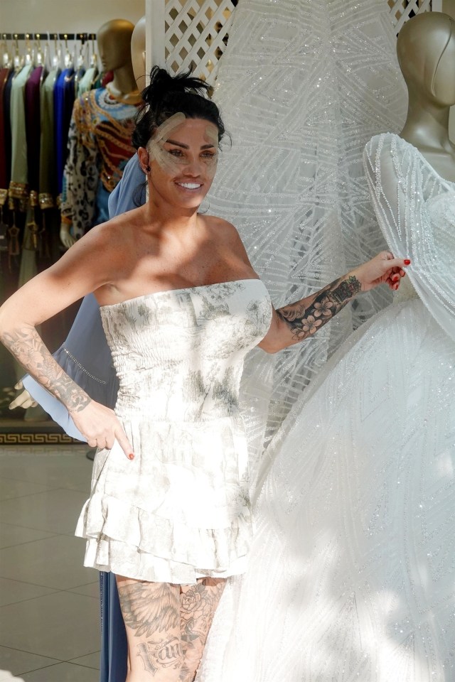 a woman in a white dress with a tattoo on her leg