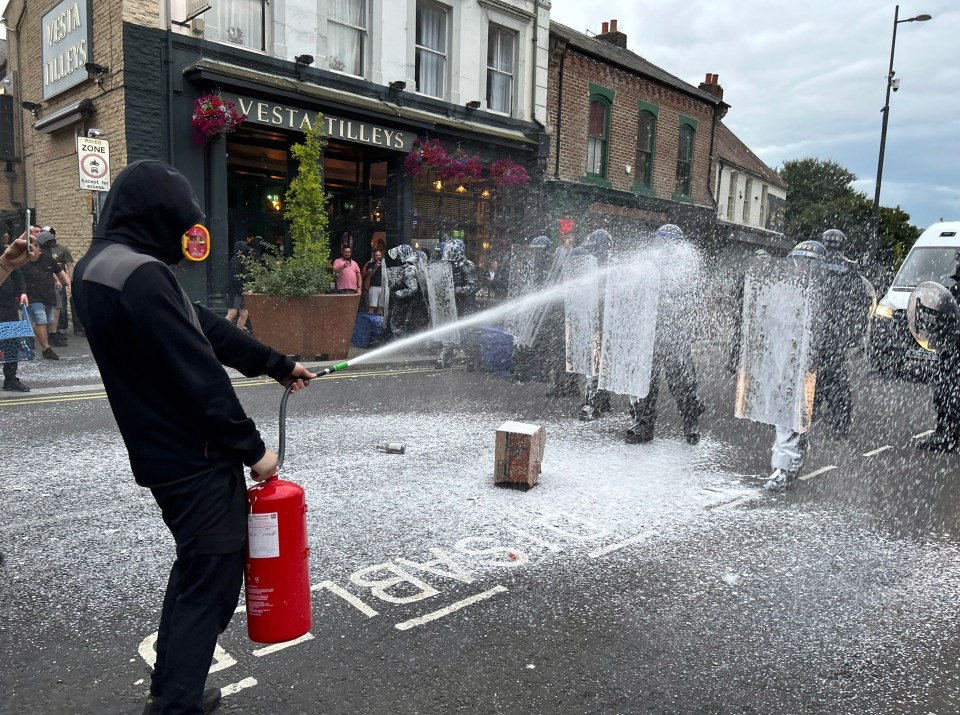 Cops were sprayed with a fire extinguisher as they battled against a volley of attacks in Sunderland