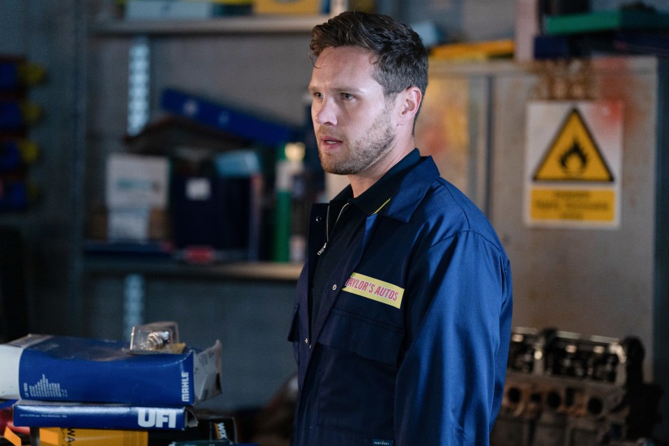 a man wearing a blue overall with the word auto on it