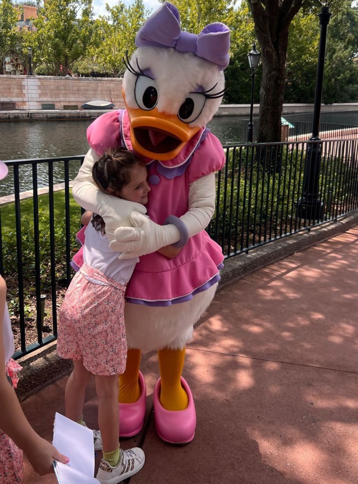 Phoebe was seen giving Daisy Duck a huge hug, as one of the other children waited to get the character's autograph