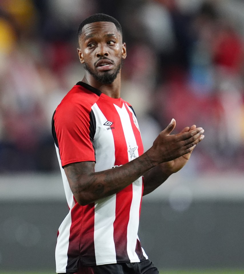 a soccer player wearing a red and white striped shirt with the word umbro on it