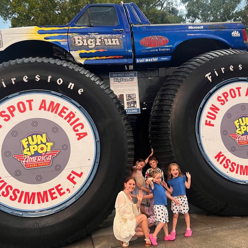 a family poses in front of a monster truck that says big fun