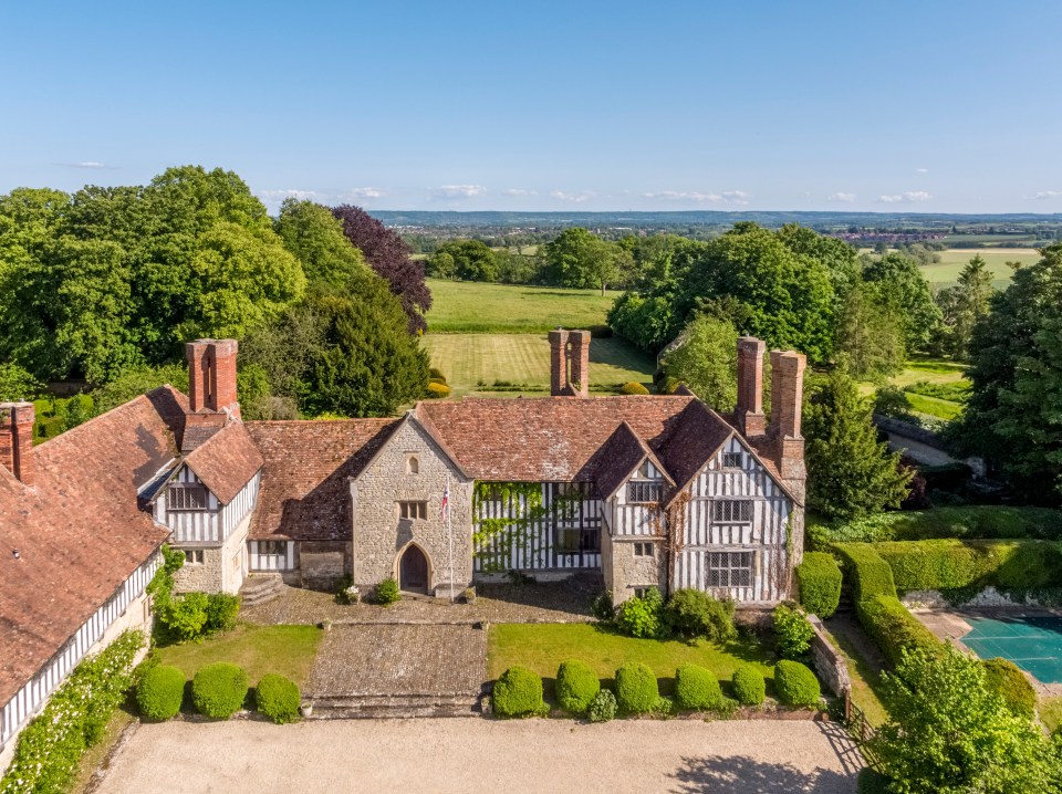 an aerial view of a large house surrounded by trees