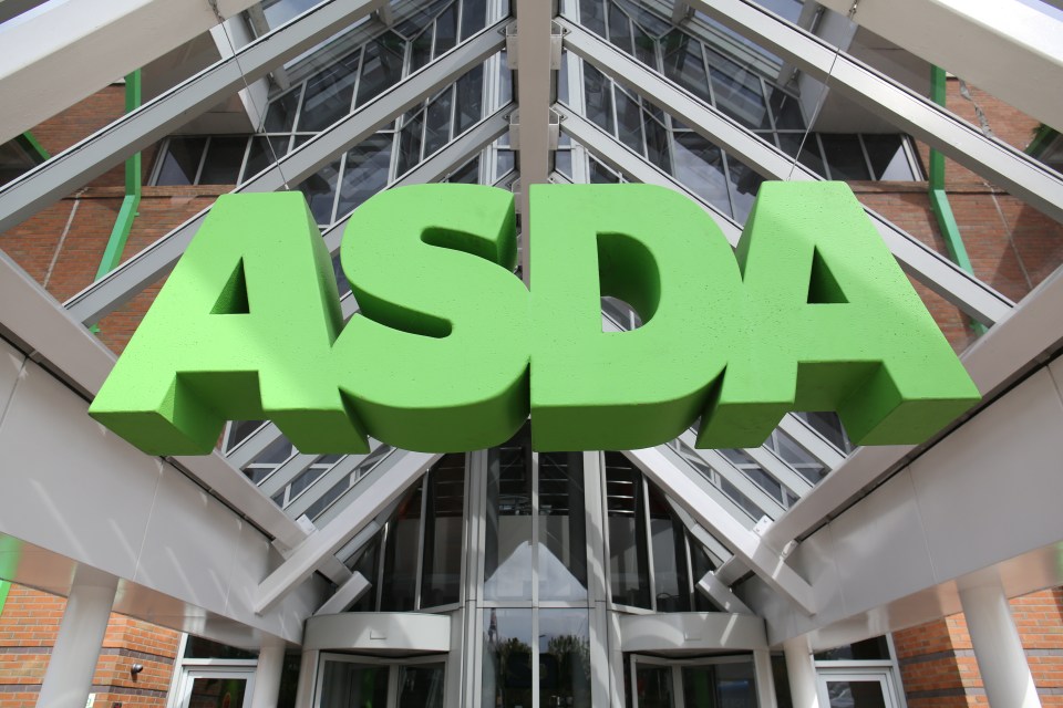 a green asda sign hangs over the entrance to a store