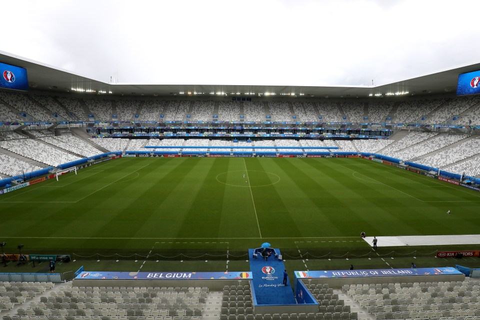 an empty soccer stadium with the word belgium on the side