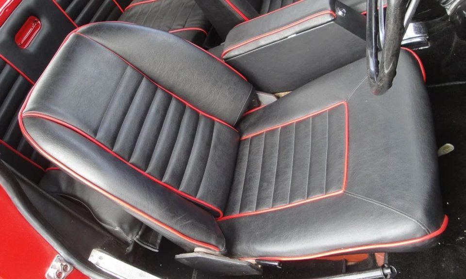 The roadster features a pristine red lined interior