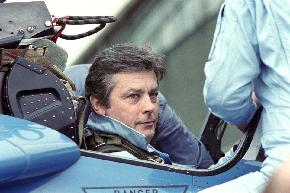 a man sits in the cockpit of a plane with the word danger on the side