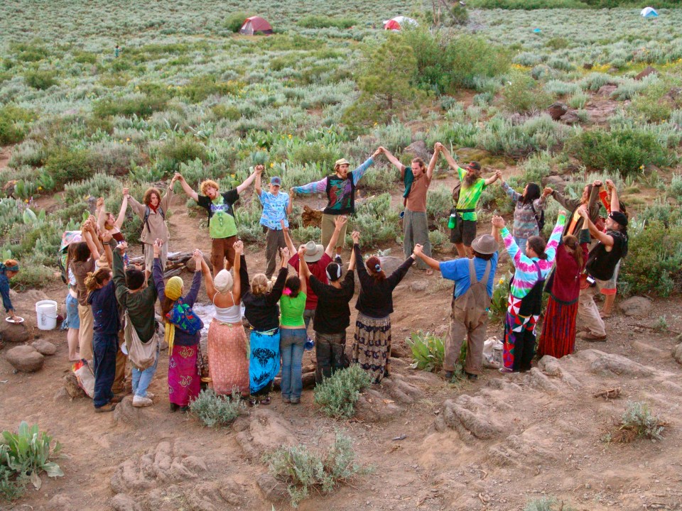 a group of people are holding hands in a circle