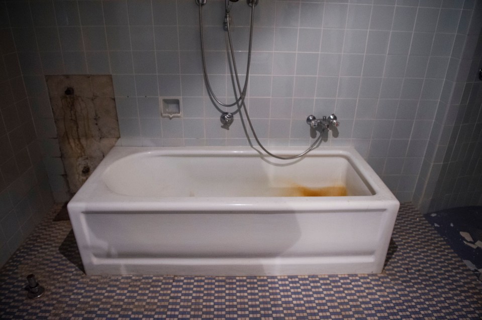 a bathtub with a shower head attached to it