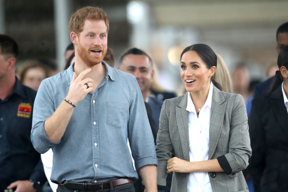 prince harry and meghan markle are standing next to each other