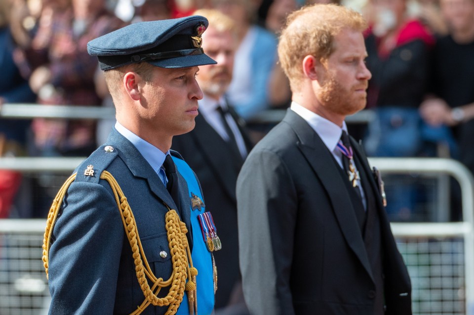 a man in a blue uniform stands next to a man in a black suit