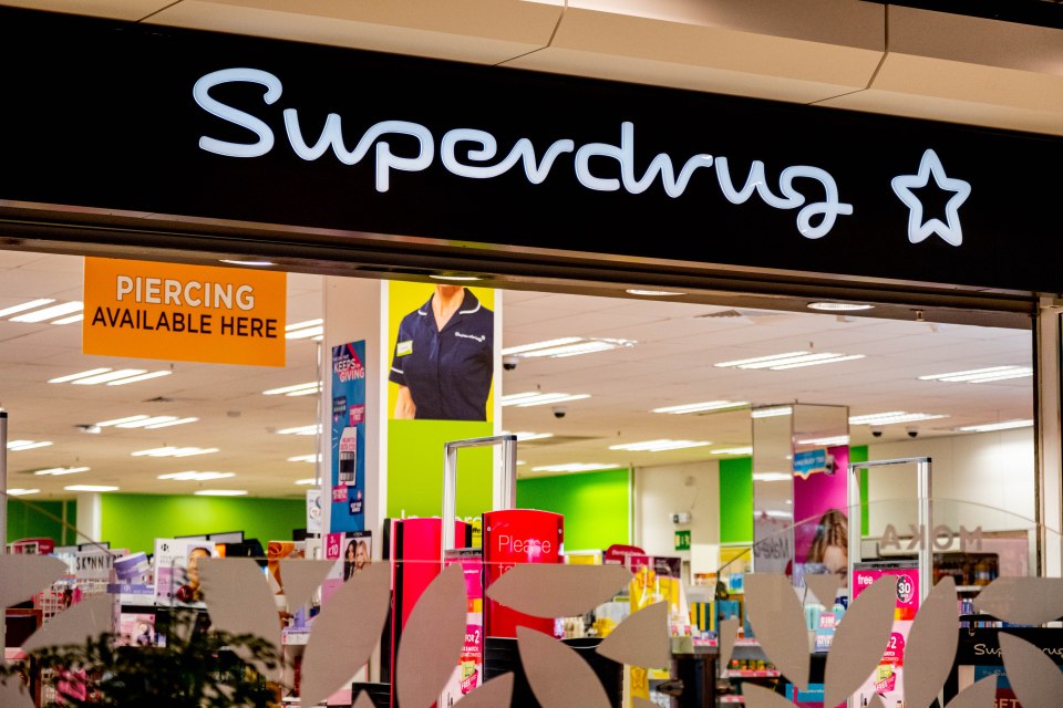 a superdrug store with a sign that says piercing available here