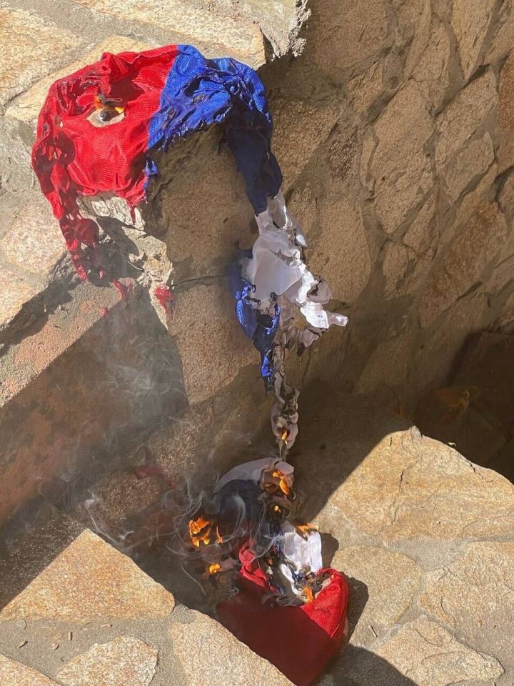 A Russia flag is burnt on the ground by a Mavka operative