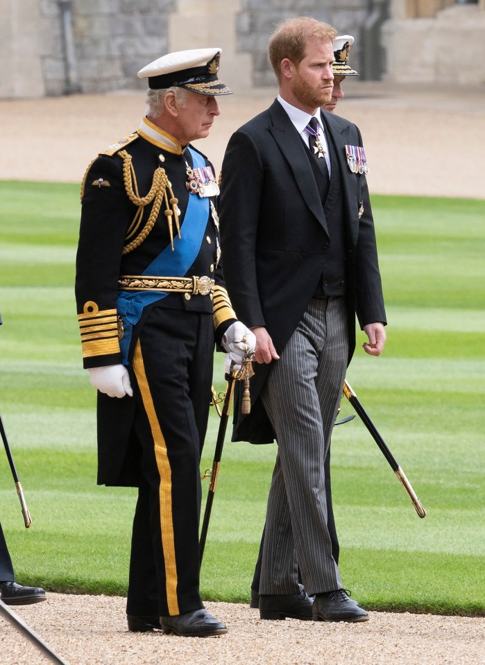 a man in a military uniform stands next to a man in a suit