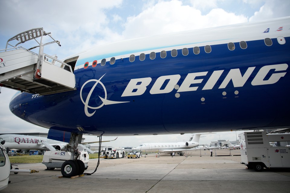 A grounded Boeing jet at an airfield