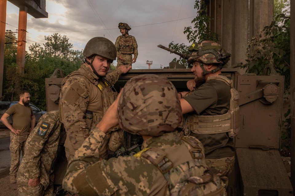 Ukrainian troops chat in a moment of calm near combat zones