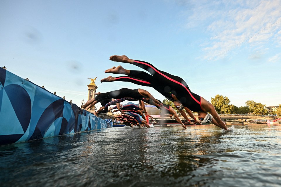 a group of people are diving into a body of water