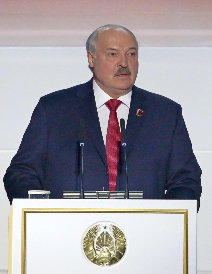 a man in a suit and tie stands at a podium