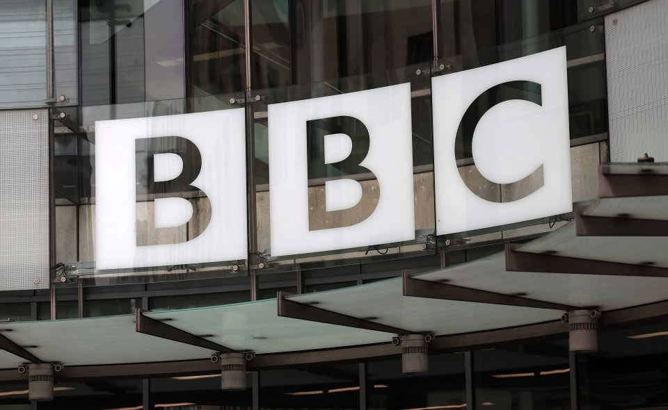 a bbc sign hangs from the side of a building