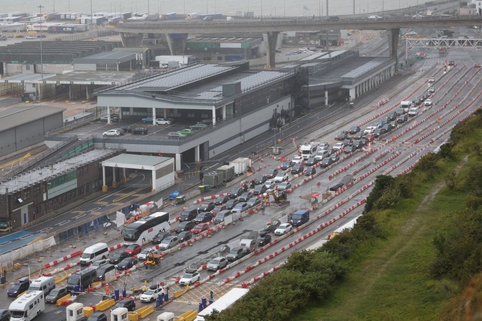 an aerial view of a busy highway with a large building in the background