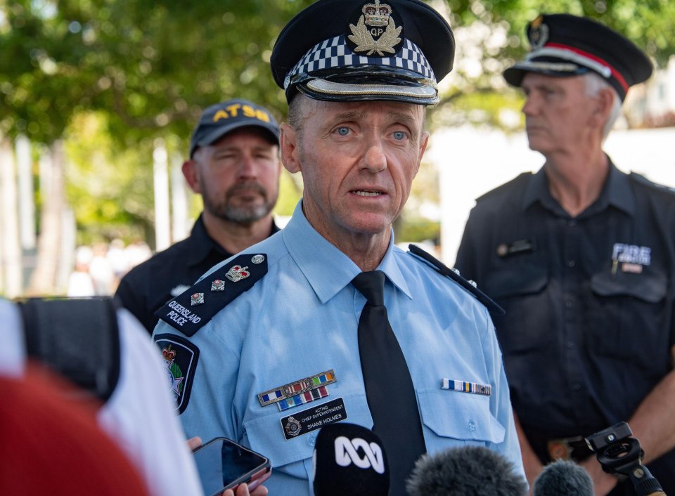 a man in a police uniform talks into a microphone