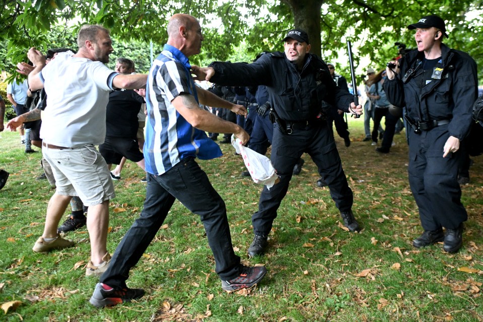 Police officers face protesters in Bristol as the violence escalates