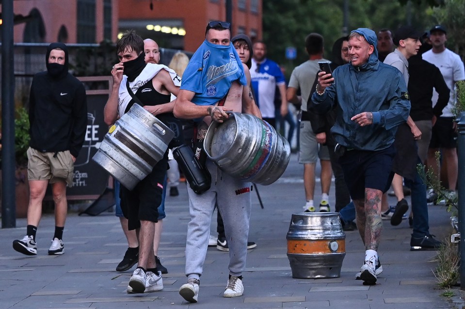 People carry beer kegs in Bristol during the 'Enough is Enough' demonstration