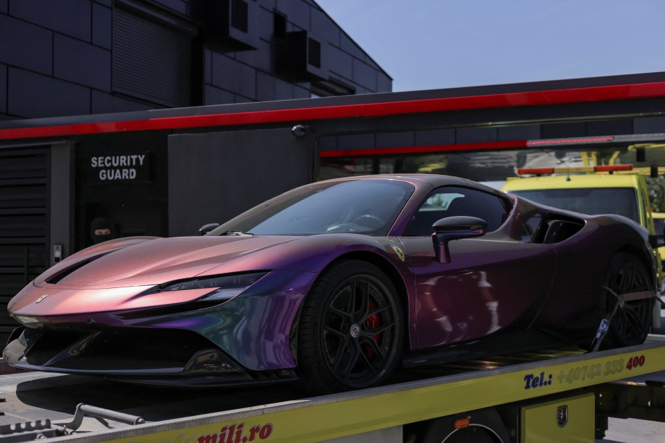 A Ferrari SF 90 Stradale is removed from Andrew Tate’s residence in Voluntari, near Bucharest, Romania