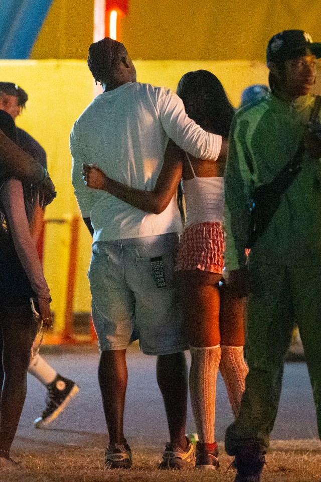 a man and a woman hugging with the man wearing a hat that says new york yankees