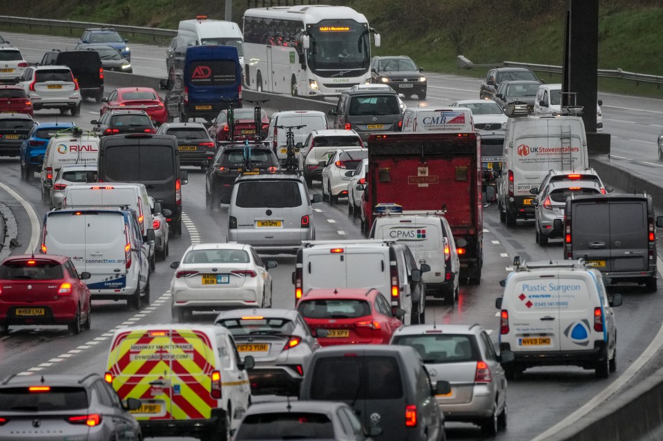 a busy highway with a van that says plastic surgery on it