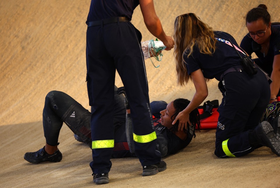 The Brit was receiving medical attention after falling from his bike