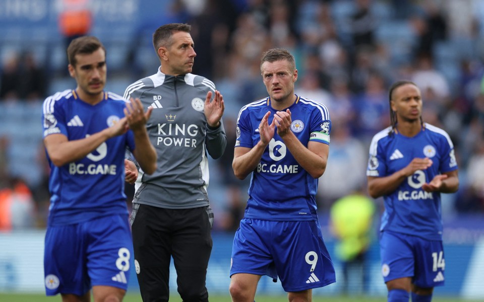 a group of soccer players wearing blue jerseys that say king power